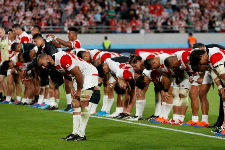 Japan captain Michael Leitch leads his team in bowing to the Tokyo crowd after losing to South Africa.