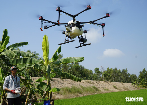 Crop dusting drones roam the skies above southern Vietnam’s paddy fields
