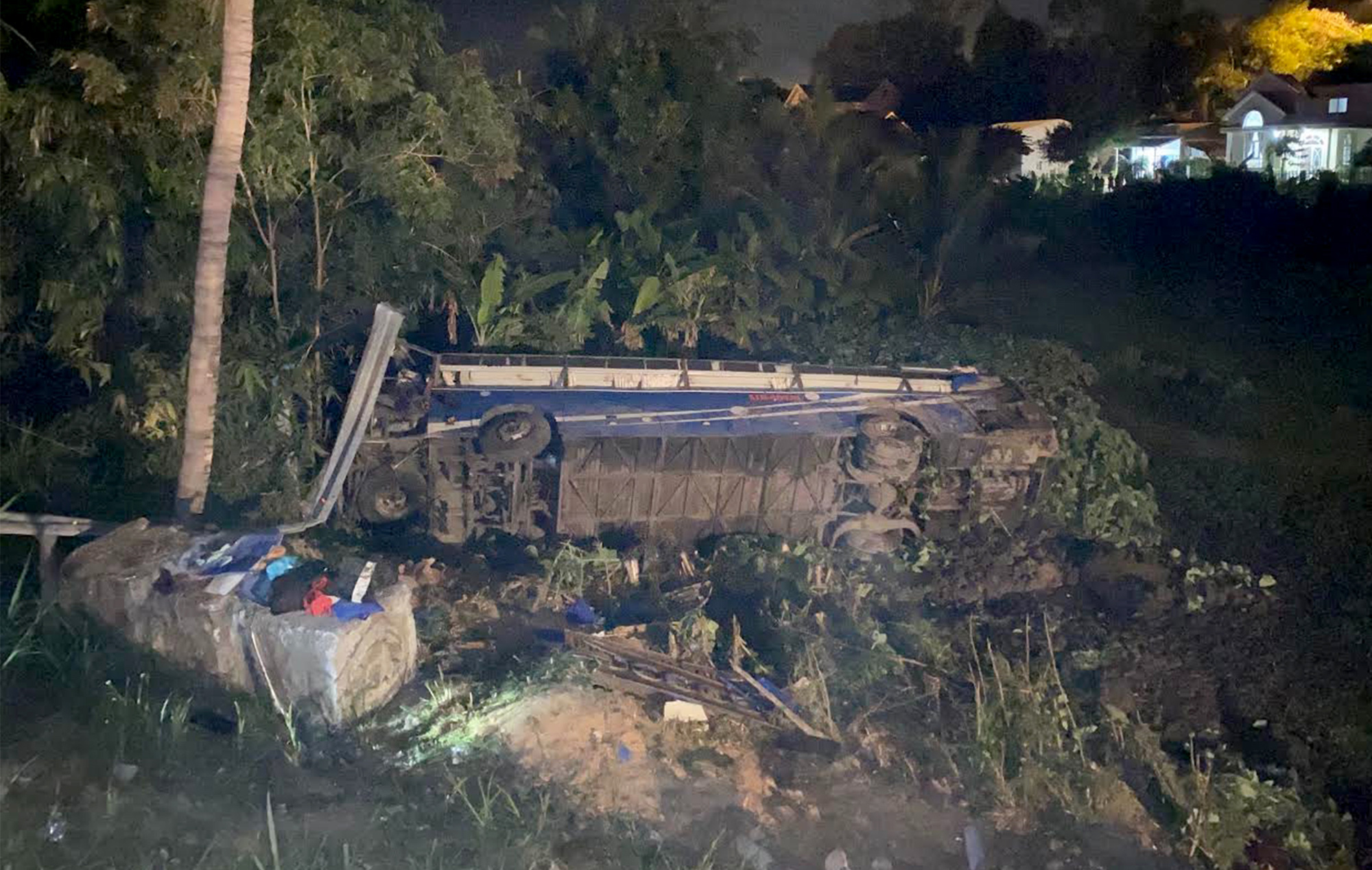 A passenger bus is on its side after it plunged into a roadside paddy field and toppled in Phu Yen Province, Vietnam on January 26, 2020. Photo: Pham Thanh / Tuoi Tre