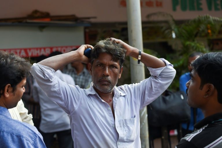 Migrant labourer Munna Singh (C), 45, waits for work at a junction in Mumbai on January 24, 2020. Photo: AFP