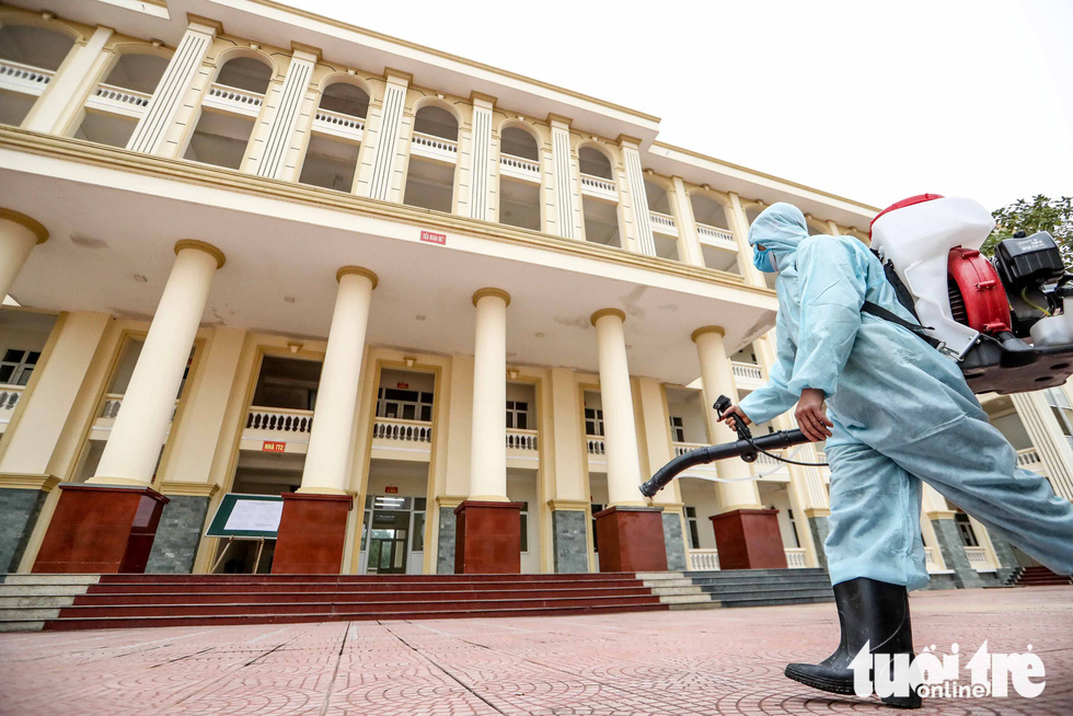 A staff in a protective suit disinfect the military school under the High Command of Capital Hanoi in Son Tay Town, Hanoi, on February 6, 2020. Photo: Nguyen Khanh / Tuoi Tre