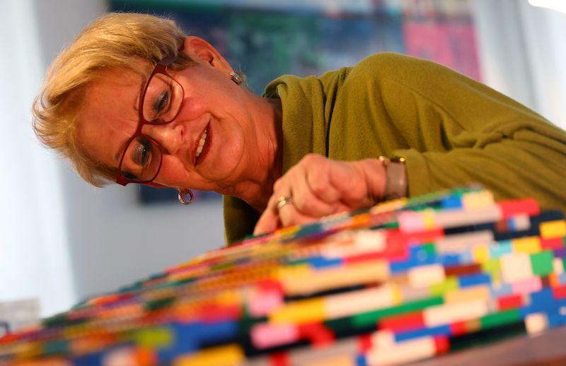 Rita Ebel, nicknamed 'Lego grandma,' builds a wheelchair ramp from donated Lego bricks in the living room of her flat in Hanau, Germany, February 17, 2020. Picture taken February 17, 2020. Ebel started to build the ramps almost one year ago to raise awareness for handicapped people in her hometown of Hanau. Meanwhile, dozens of stores use the ramps to ease entry for wheelchair users.  Photo: Reuters