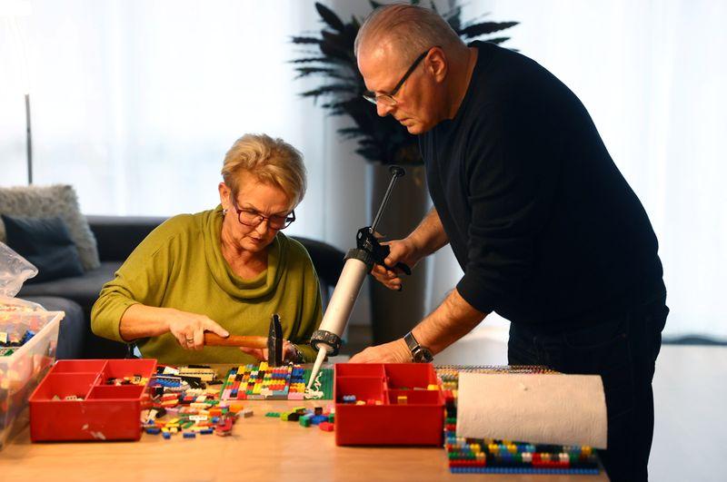 Rita Ebel (L), nicknamed 'Lego grandma,' and her husband Wolfgang build a wheelchair ramp from donated Lego bricks in the living room of their flat in Hanau, Germany, February 17, 2020. Picture taken February 17, 2020. Ebel started to build the ramps almost one year ago to raise awareness for handicapped people in her hometown of Hanau. Meanwhile, dozens of stores use the ramps to ease entry for wheelchair users.  Photo: Reuters