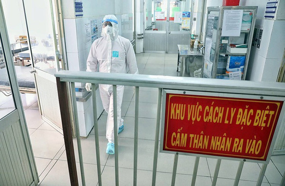 A medical worker in protective suit walks by a sign informing of a quarantine zone at a hospital in Vietnam in this undated file photo. Photo: Tuoi Tre