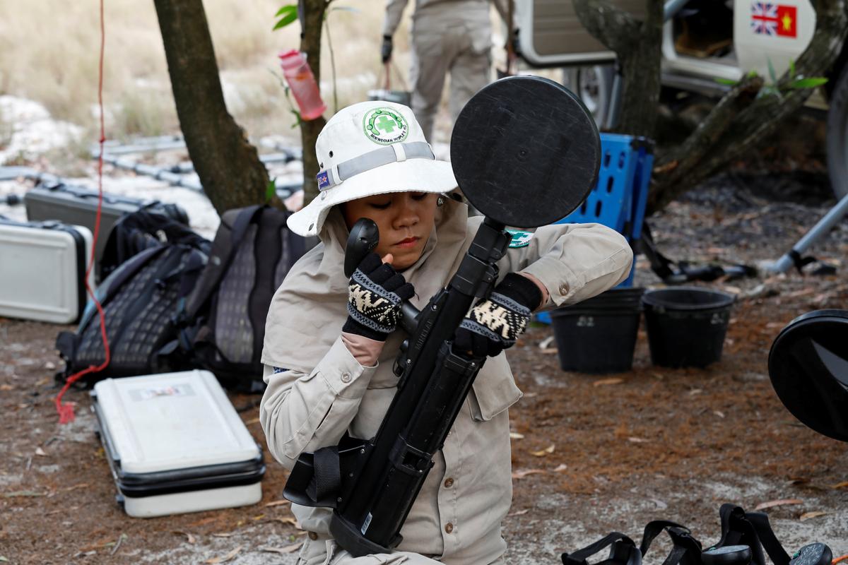 A member of all-female landmines clearance team prepares equipment for their work on a field in Quang Tri province, Vietnam March 4, 2020. Picture taken March 4, 2020. Photo: Reuters