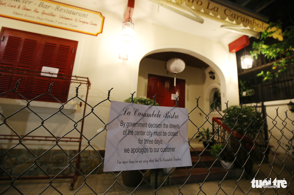 A circular announcing the temporary business closures posted on a fence outside a restaurant in Hue, the capital city of the central province of Thua Thien-Hue, Vietnam, March 11, 2020. Photo: Phuoc Tuan / Tuoi Tre