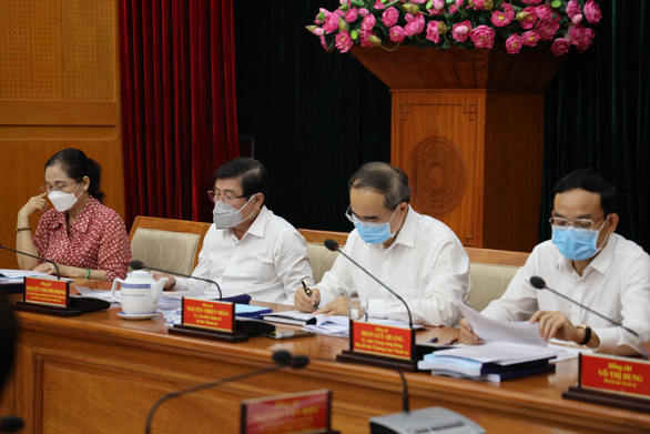 Ho Chi Minh City officials wearing face masks attend a meeting to discuss the suspension of local entertainment activities, including bars and beer clubs, in this provided photo taken on March 12, 2020.