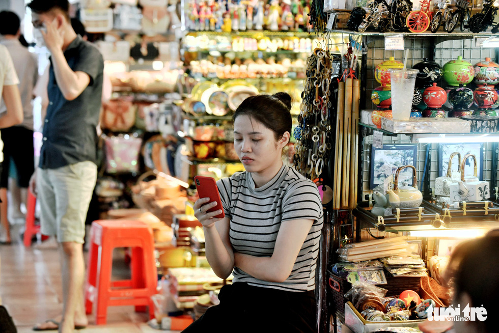 A shop attendant is spotted not wearing a face mask at the iconic Ben Thanh Market in District 1, Ho Chi Minh City, Vietnam, March 16, 2020. Photo: Duyen Phan / Tuoi Tre