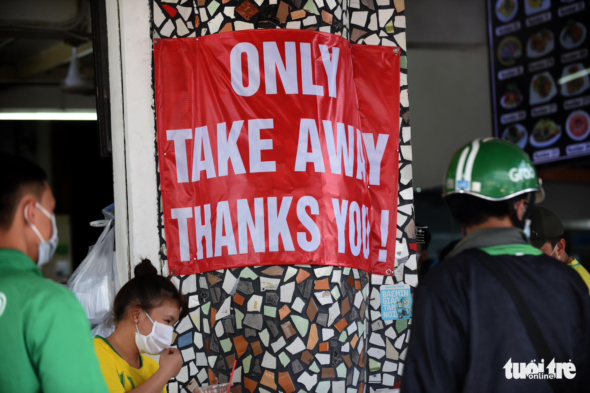 An English sign posted outside a restaurant in District 1, Ho Chi Minh City, Vietnam announcing its takeaway-only policy. Photo: Duyen Phan / Tuoi Tre