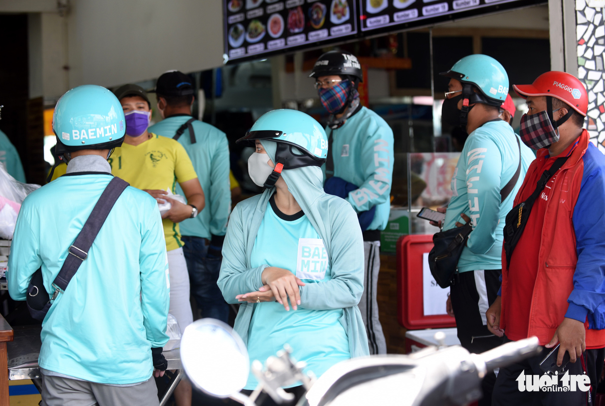 Delivery drivers wait for their orders to be prepared at a restaurant in Ho Chi Minh City, Vietnam. Photo: Duyen Phan / Tuoi Tre
