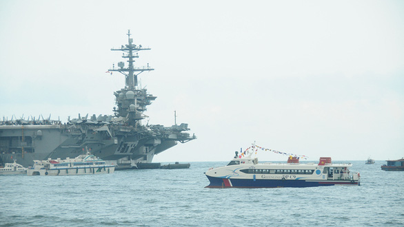 The Greenlines DP C9 fast ferry is seen near the U.S. aircraft carrier USS Theodore Roosevelt off the central Vietnamese city of Da Nang, March 2020. Photo: B.D. / Tuoi Tre