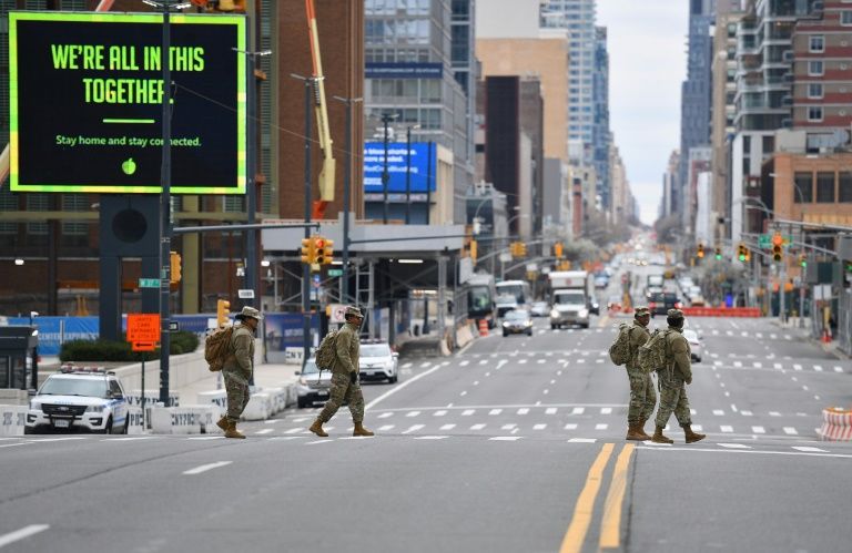 Members of the Army National Guard cross the street by the Jacob K. Javits Convention Center on March 31, 2020 in New York City. Photo: AFP