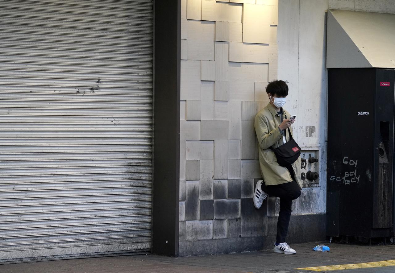 A man wearing a protective mask uses a mobile phone, following the coronavirus disease (COVID-19) outbreak, in Tokyo, Japan April 7, 2020.  Photo: Reuters