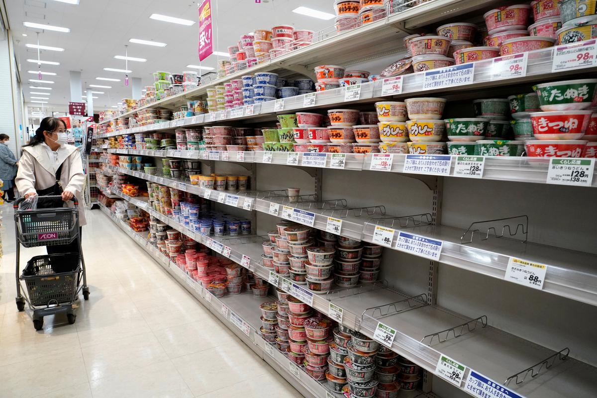 A shopper, wearing a protective mask, looks at shelves at a supermarket, following the outbreak of coronavirus disease (COVID-19), in Tokyo, Japan April 7, 2020.  Photo: Reuters