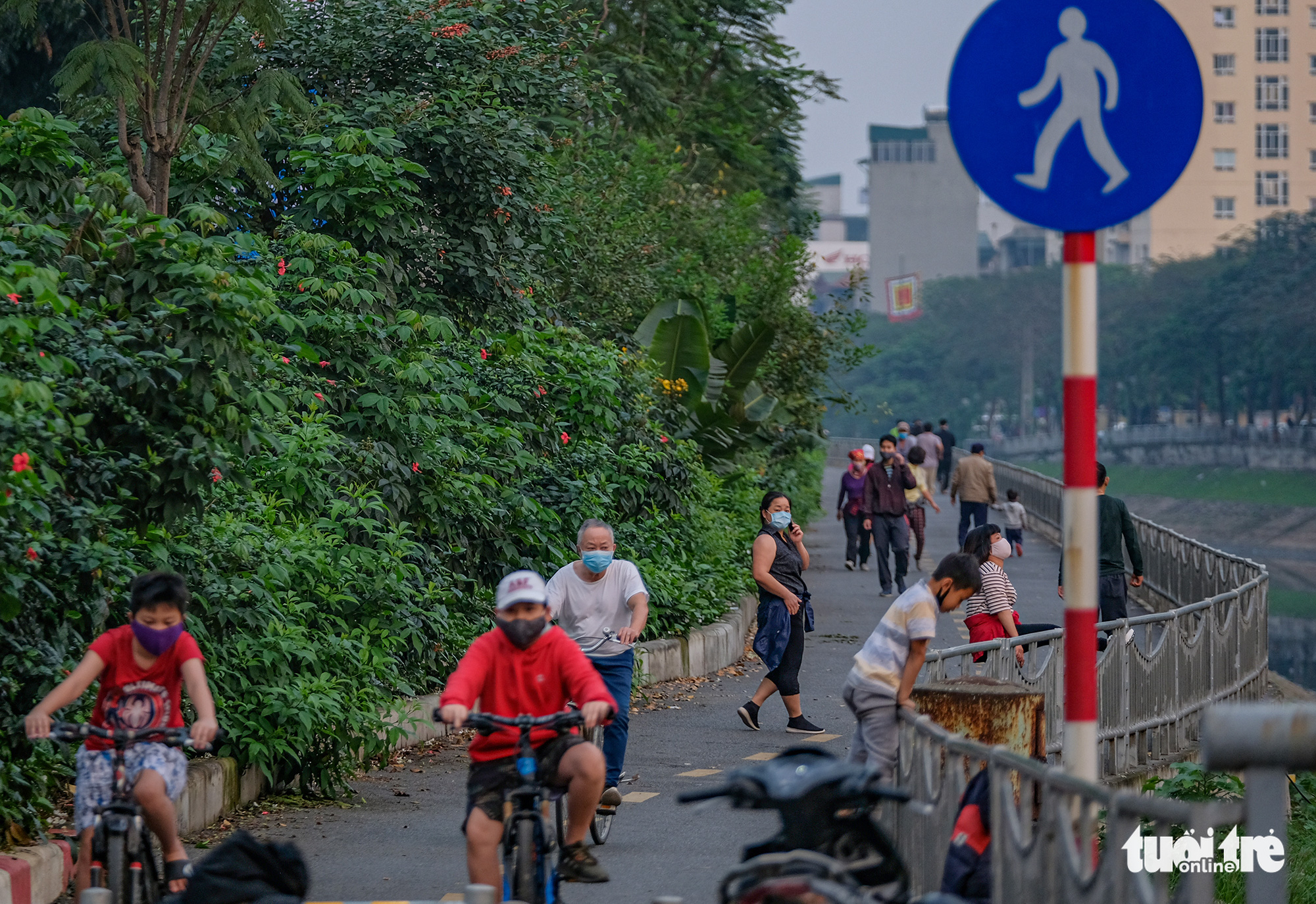 Residents exercise on a pedestrian lane of Lang Street along To Lich River in Hanoi, Vietnam in this photo taken in early April 2020. Photo: Nam Tran / Tuoi Tre