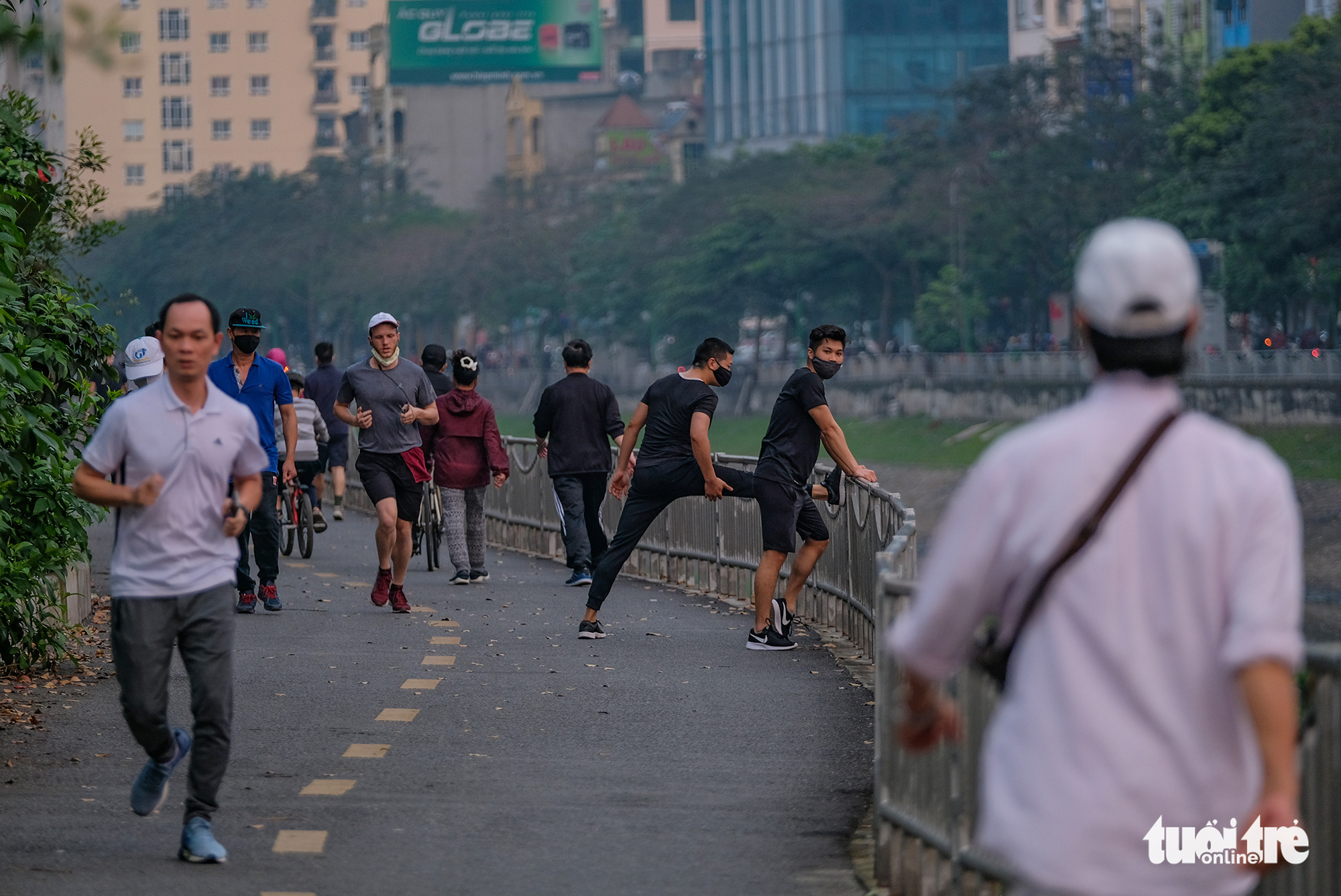 Residents exercise on a pedestrian lane of Lang Street along To Lich River in Hanoi, Vietnam in this photo taken in early April 2020. Photo: Nam Tran / Tuoi Tre
