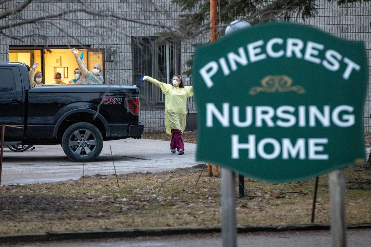 Workers wave at passing cars honking their horns in support for Pinecrest Nursing Home after several residents died and dozens of staff were sickened by coronavirus disease (COVID-19) in Bobcaygeon, Ontario, Canada March 30, 2020. Photo: Reuters