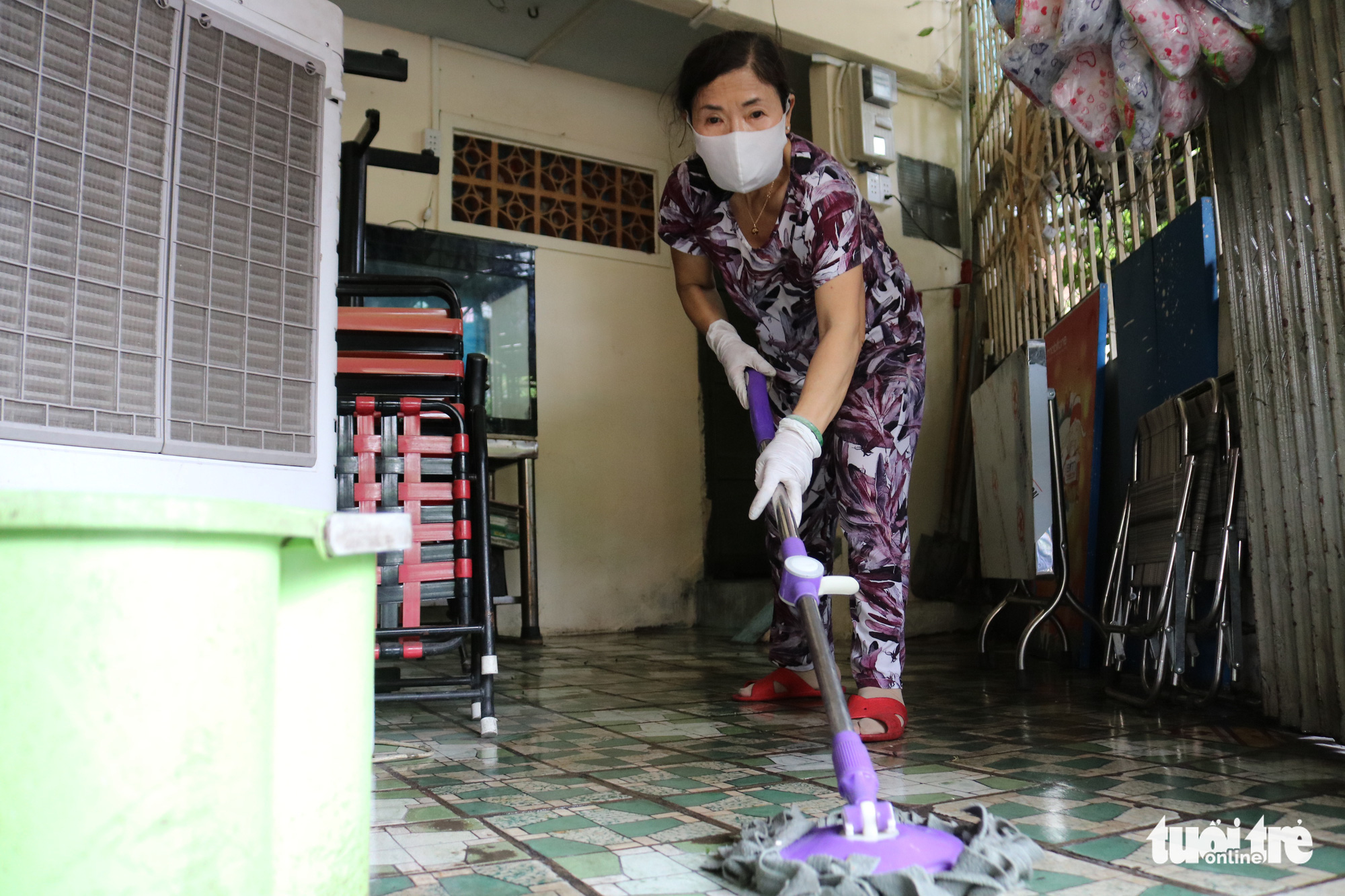 Eatery owner Chung Thi Vui cleans the venue to prepare for reopening after the announcement of eased social distancing measures in Ho Chi Minh City, Vietnam, April 22, 2020. Photo: Ngoc Phuong / Tuoi Tre