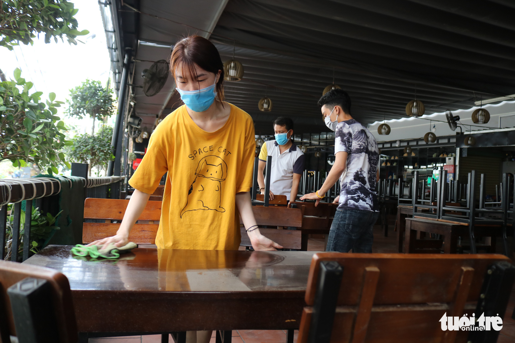 Staff members of a restaurant on Phan Dang Luu Street in Ho Chi Minh City, Vietnam sanitize the venue to prepare for reopening after the announcement of eased social distancing measures, April 22, 2020. Photo: Ngoc Phuong / Tuoi Tre