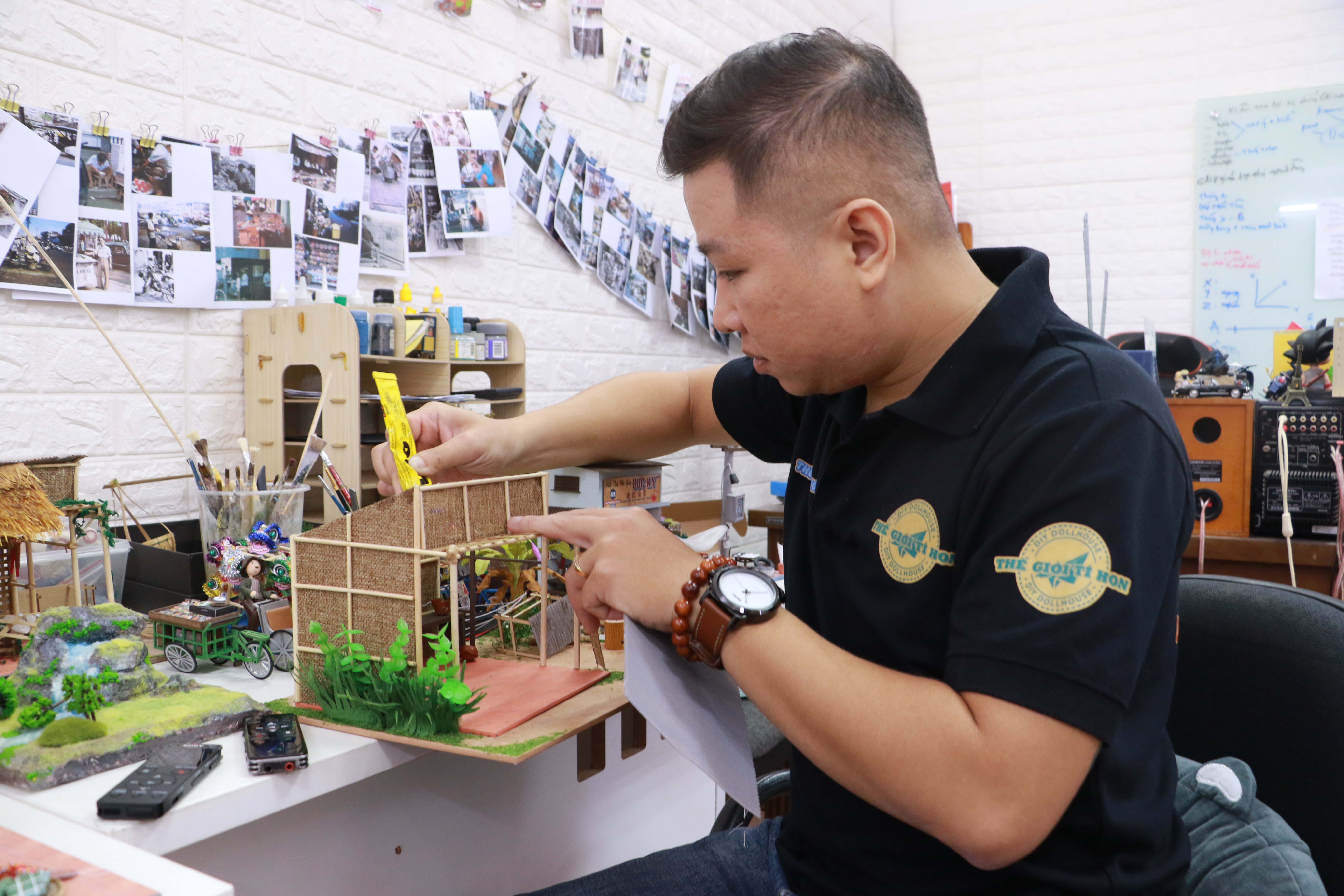 Nguyen Phuc Duc is seen working on a new product featuring a house in the countryside of the Mekong Delta region in Vietnam. Photo: Binh Minh/Tuoi Tre