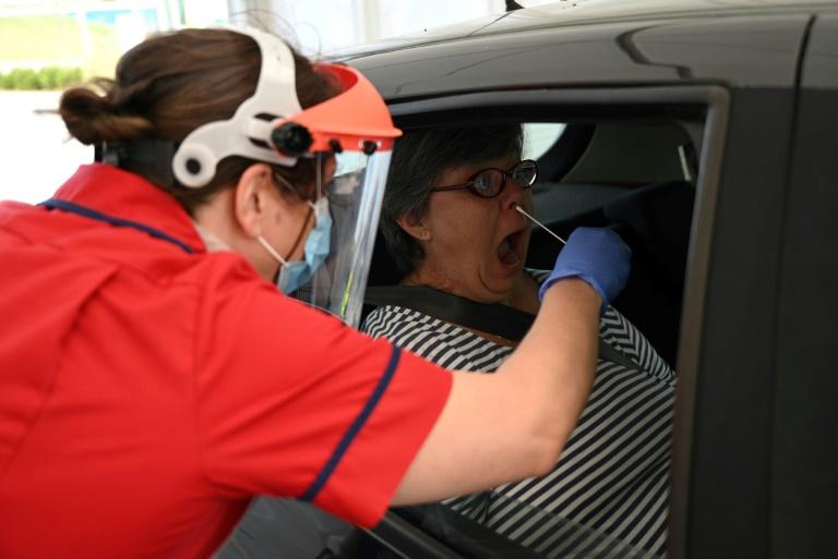 Clinical staff test a key worker for the novel coronavirus at the Royal Papworth Hospital in Britain, which has suffered a rising coronavirus death toll. Photo: AFP