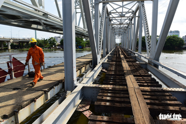 Workers are seen working on the dismantlement of the 118-year-old Binh Loi Railway Bridge in Ho Chi Minh City, Vietnam, May 8, 2020. Photo: Quang Dinh / Tuoi Tre