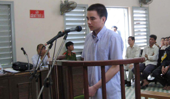 Ho Duy Hai, who was sentenced to death for killing two young female postal workers in Long An Province, Vietnam in 2008, stands trial at a court in this file photo.