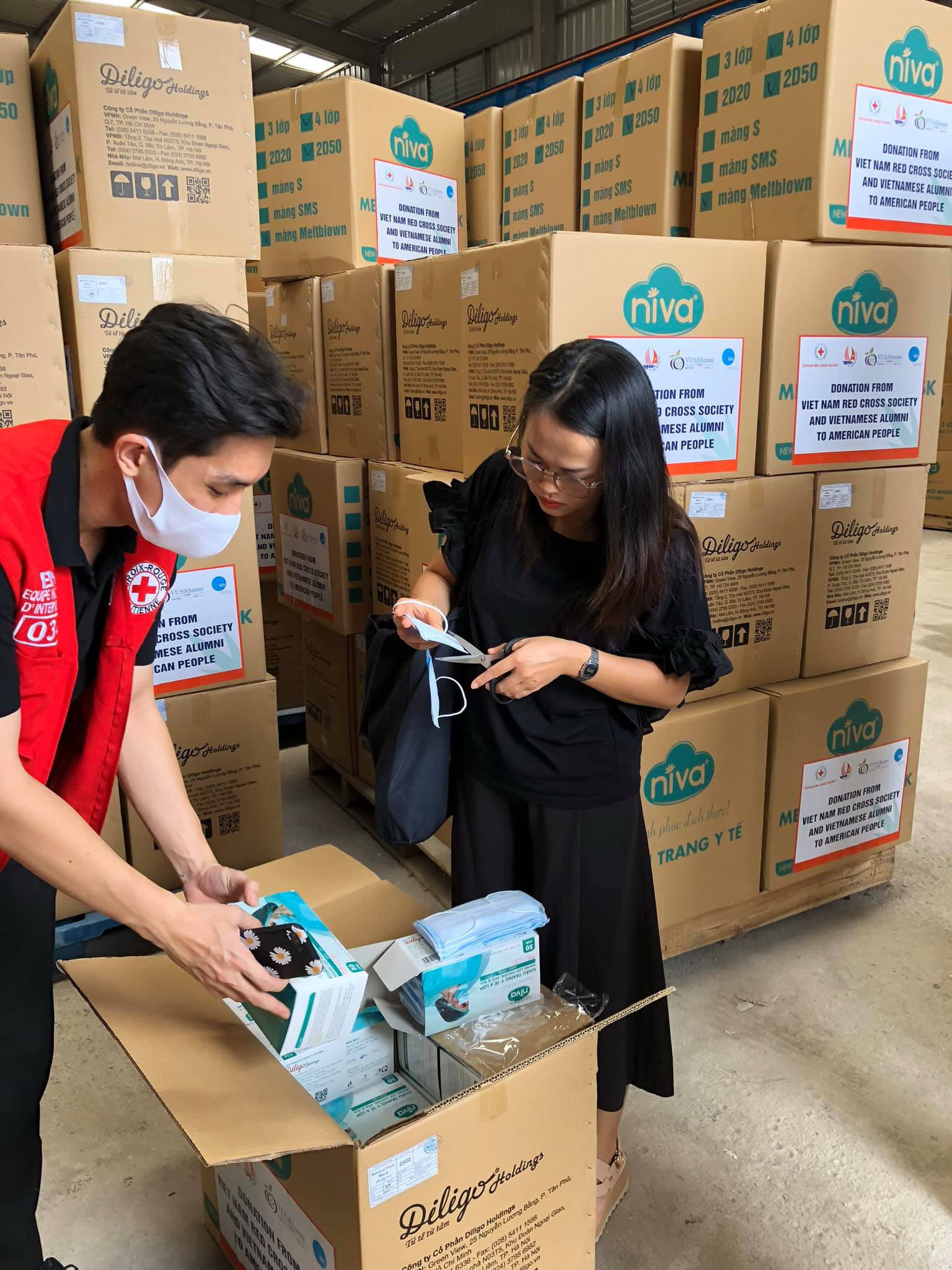 Representative of the Vietnam-U.S. Alumni Club (VUSAC) in Hanoi inspect the quality of donated face masks before sending them en route to the U.S. in this photo supplied by VUSAC Hanoi.