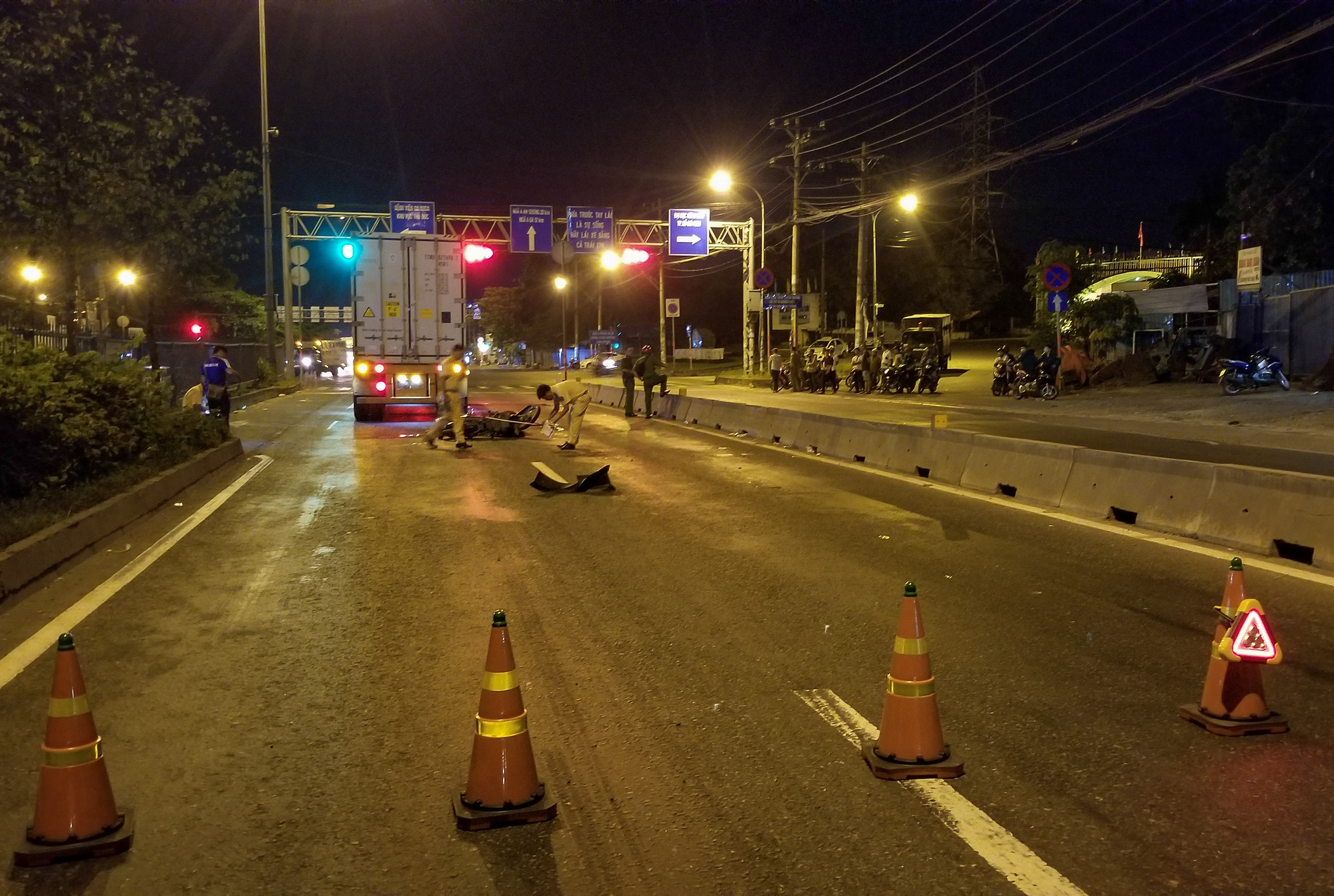 Police officers probe a crash site along National Highway No.1 in Thu Duc District, Ho Chi Minh City, July 12, 2020. Photo: Chau Tuan / Tuoi Tre