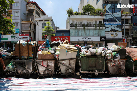 <em>Uncollected garbage piles up on a street in an urban district of Hanoi, Vietnam, July 16, 2020. Photo: </em>Chi Tue / Tuoi Tre
