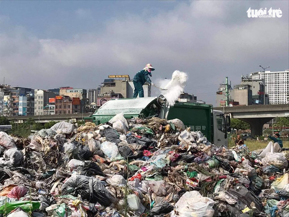 <em>Uncollected garbage piles up on a street in an urban district of Hanoi, Vietnam, July 16, 2020. Photo:</em> Xuan Long / Tuoi Tre