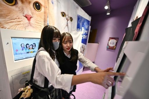 Teenagers in Tokyo pose at a Japanese photo booth known as a 'purikura'. Photo: AFP