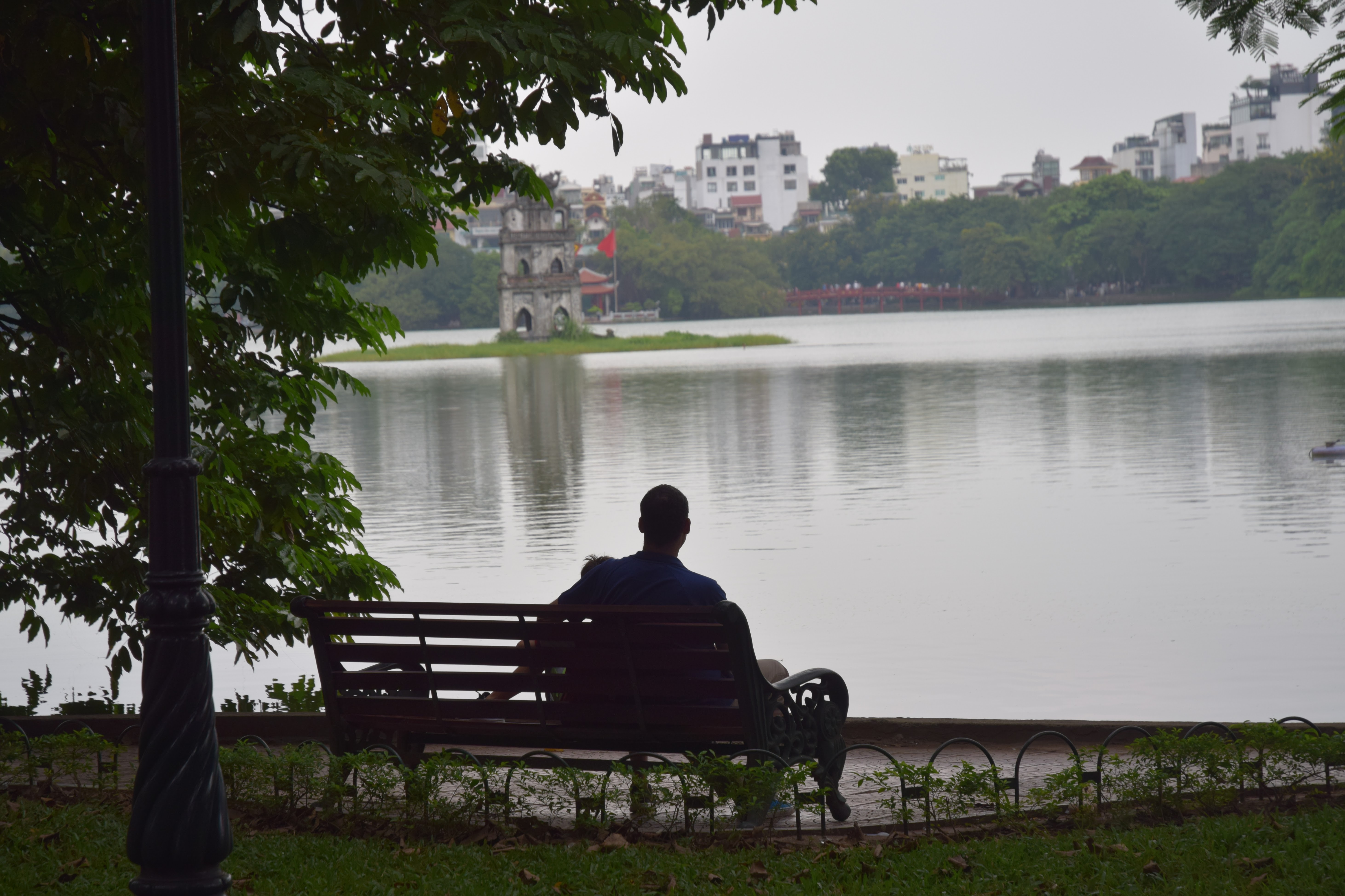 Kyle Nunas and his son at Hoan Kiem Lake in 2018 in a photo provided to Tuoi Tre News. 'I took a photo of a stranger from nearly this exact spot 20 years ago, Nunas wrote a caption for this photo.