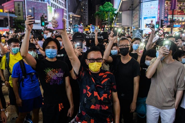 Participants hold up their cellphone's flash lights as they take part in a rally in Central district on June 9, 2020 in Hong Kong, China. Photo: AFP