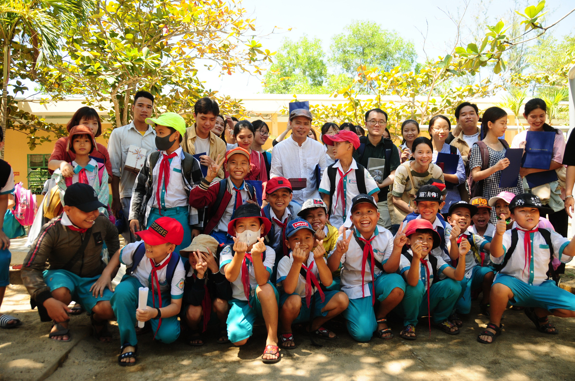 In this supplied photo, South Korean activist Kwon Hyun Woo (second row, black T-shirt with glasses) and locals attend the inauguration of a children’s playground in Dien Duong Ward, Dien Ban Town, Quang Nam Province. Photo: T.B.D. / Tuoi Tre