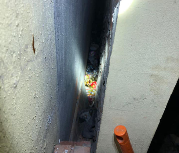This supplied photo shows a narrow wall gap where an abandoned newborn boy was rescued in Gia Lam District, Hanoi, August 18, 2020.