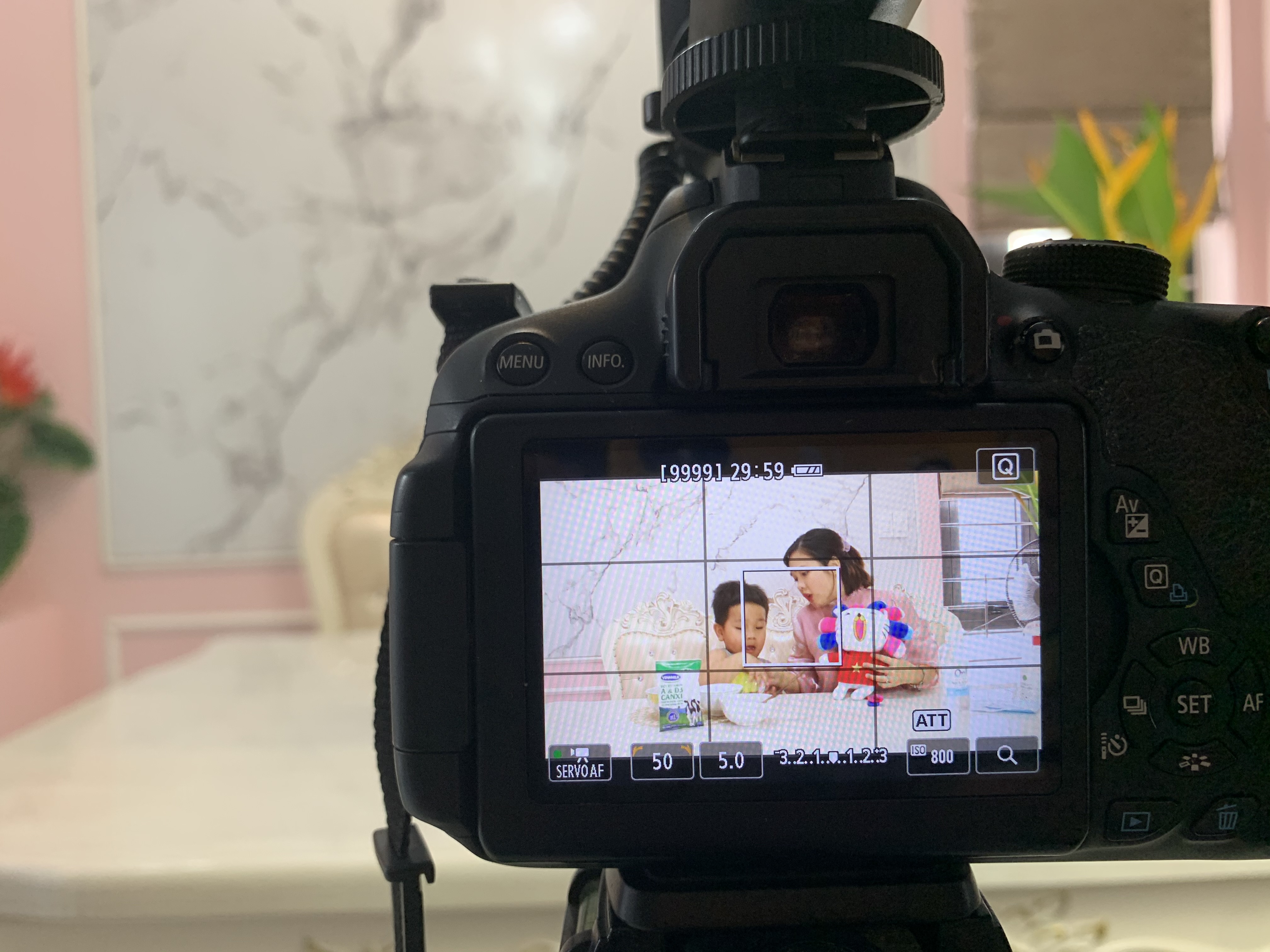 Pham Thu Huong filming a TikTok cooking video with her son.