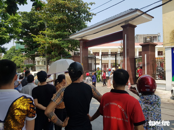 Residents stand outside a vocational school in Phu Tho Province, where four people died after land collapsed at a construction site, September 1, 2020. Photo: T. Anh / Tuoi Tre