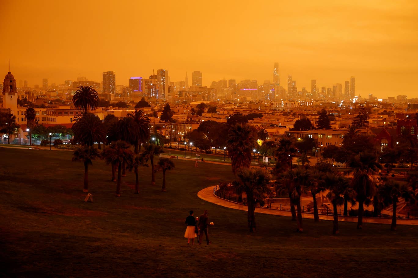 People relax under an orange smoke-filled sky at Dolores Park in San Francisco, California on September 9, 2020. Photo: AFP