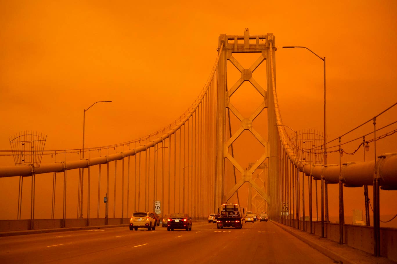 Cars drive along the San Francisco Bay Bridge under an orange smoke filled sky in San Francisco San Francisco, California on September 9, 2020. Photo: AFP
