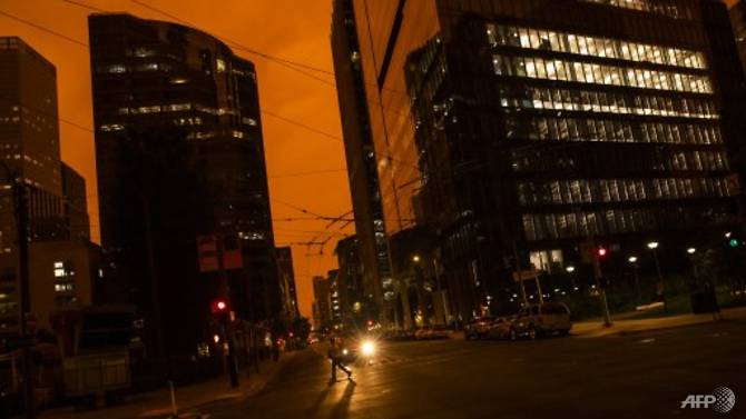 An orange glow is seen over a darkened Howard Street as smoke from various wildfires burning across Northern California mixes with the marine layer on Sep 9, 2020 in San Francisco, California. Photo: AFP