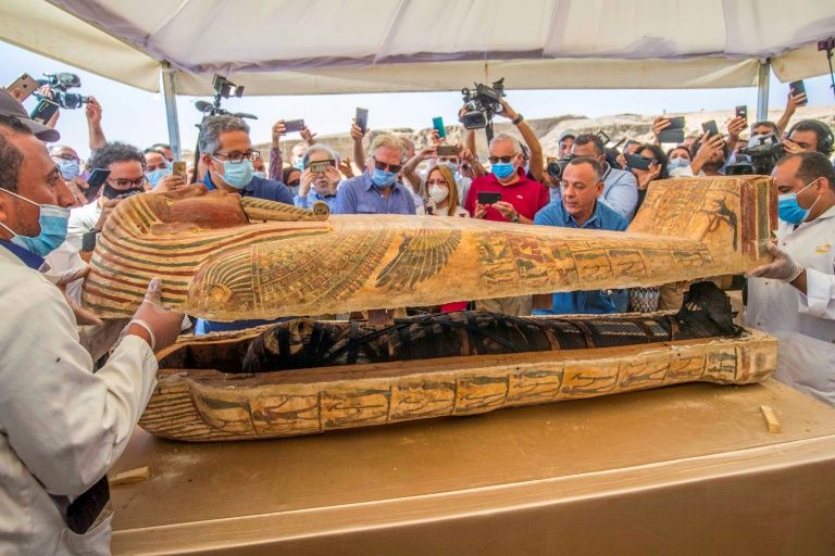 Egypt's tourism and antiquities minister, Khaled al-Anani (L), and Mostafa Waziri (R), secretary general of the Supreme Council of Antiquities, open a sarcophagus excavated at the Saqqara necropolis. Photo: AFP