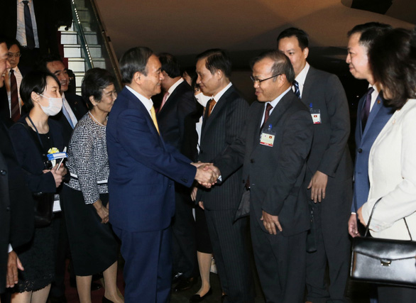 Vu Hong Nam (R), Vietnamese Ambassador to Japan, shakes hands with Japanese Prime Minister Yoshihide Suga and his spouse at Noi Bai International Airport in Hanoi, Vietnam, October 18, 2020. Photo: Vietnam News Agency