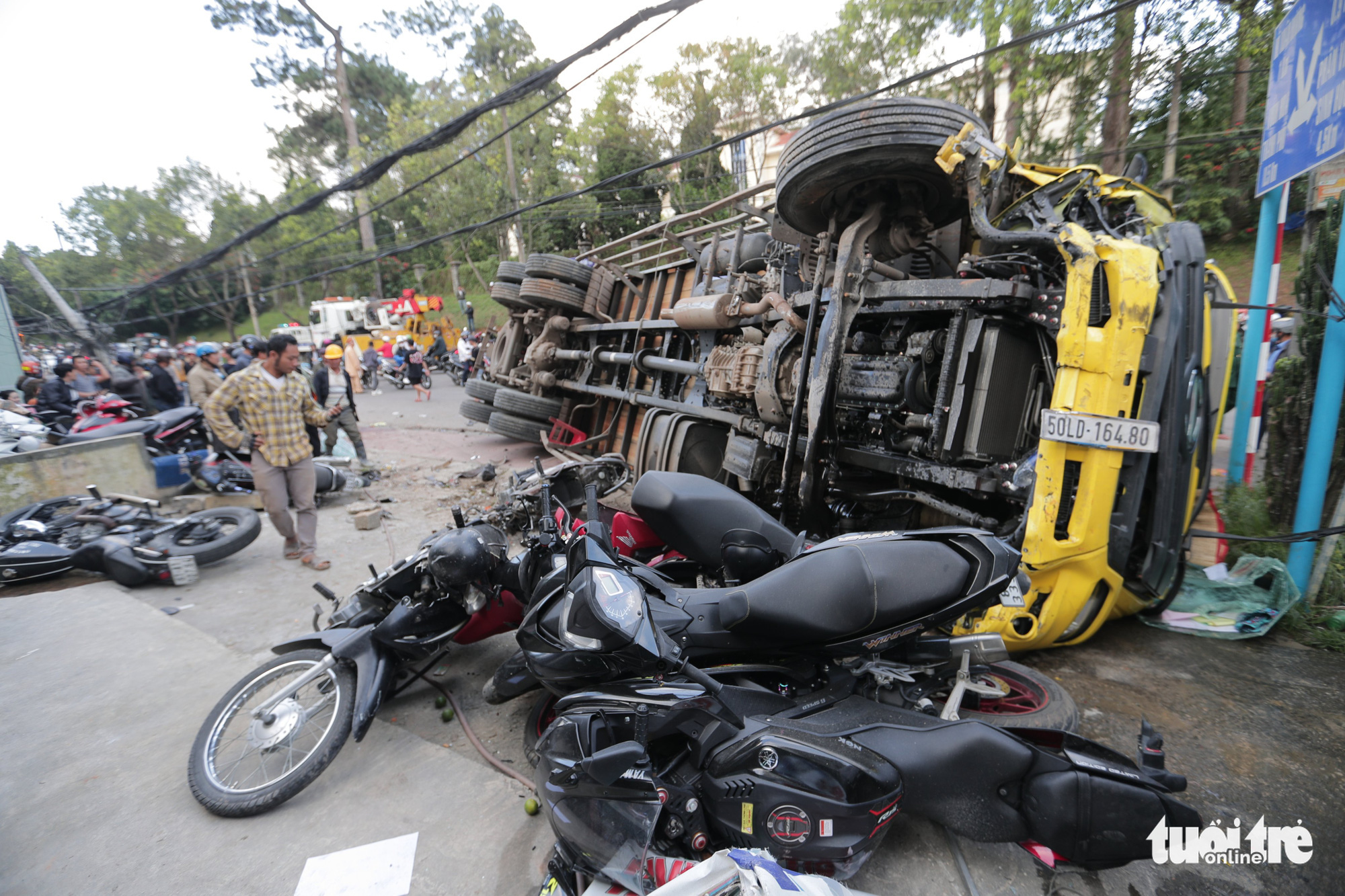 A truck is knocked on its side after sliding down a slope and crashing into multiple motorbikes in Da Lat City, Lam Dong Province, Vietnam, October 24, 2020. Photo: M.Vinh / Tuoi Tre