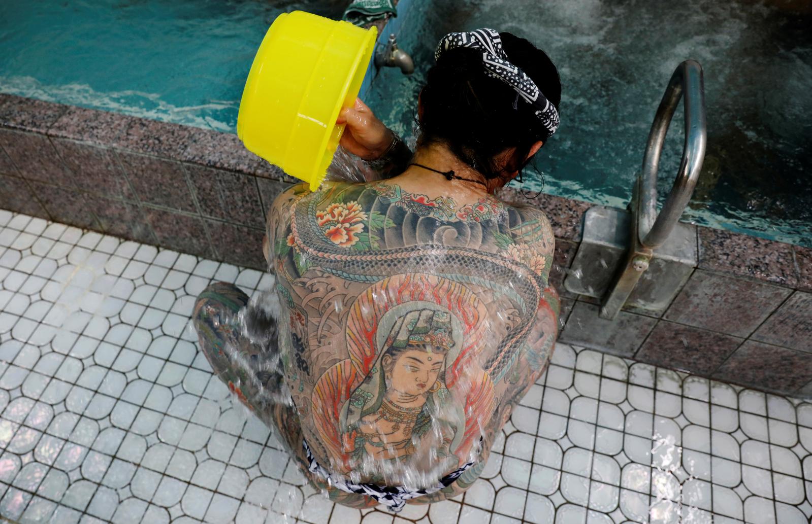 Construction worker Hiraku Sasaki, 48, washes his body at a Japanese public bath called a 'sento', as he gets together with tattoo artist Asakusa Horikazu to pose for photographs in Tokyo, Japan, September 24, 2020. Photo: Reuters