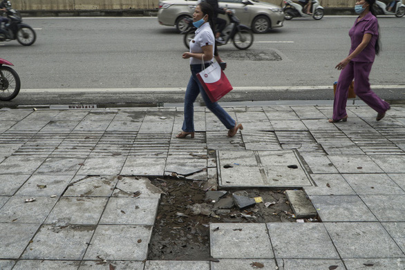 Sidewalk tiles are seen removed on a street in Hanoi. Photo: Pham Tuan / Tuoi Tre