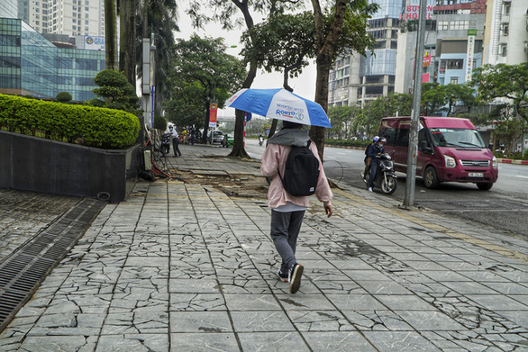 Cracked stone tiles are seen on Tran Duy Hung Street in Hanoi. Photo: Pham Tuan / Tuoi Tre
