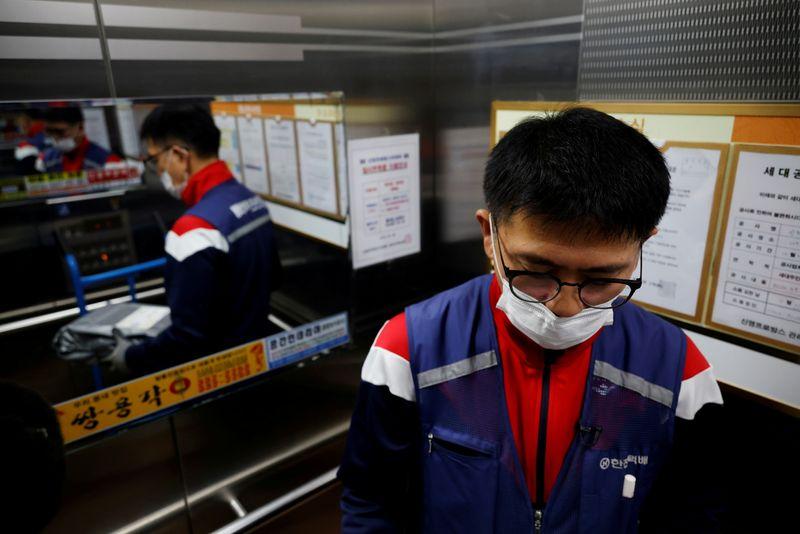 South Korean delivery workers say coronavirus boom means relentless toil