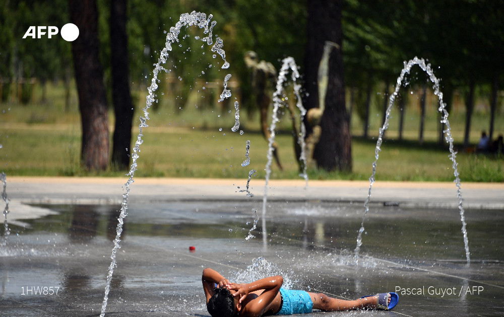 A boy cools off at a water fountain in Montpellier, southern France, on June 27, 2019 during a heat wave. Photo: AFP
