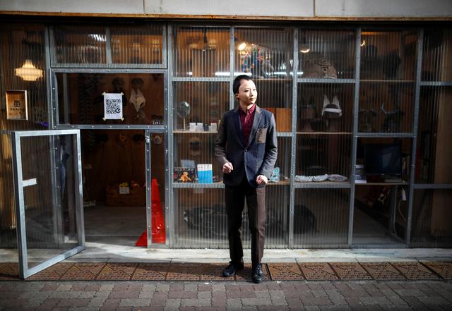 Shuhei Okawara, 30, owner of mask shop Kamenya Omote, wears a face mask based on a real person's face as he stands in front of his shop in Tokyo, Japan December 16, 2020. Photo: Reuters